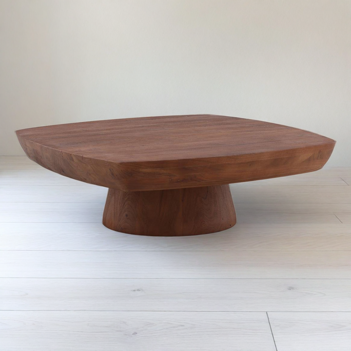Wooden coffee table with a unique design on a white floor and background