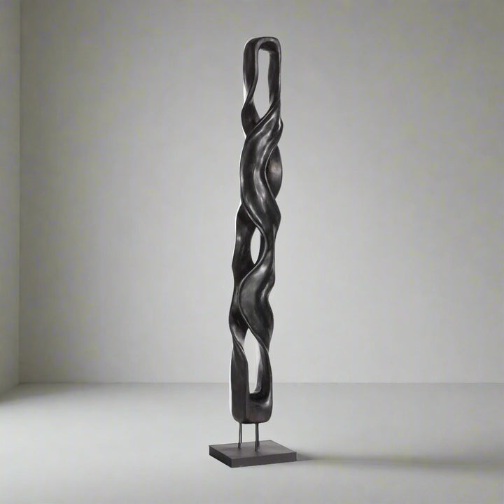 Black twisted sculpture on a white background