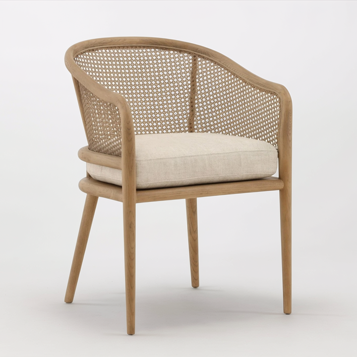 Wooden chair with woven backrest and beige cushion on a white background