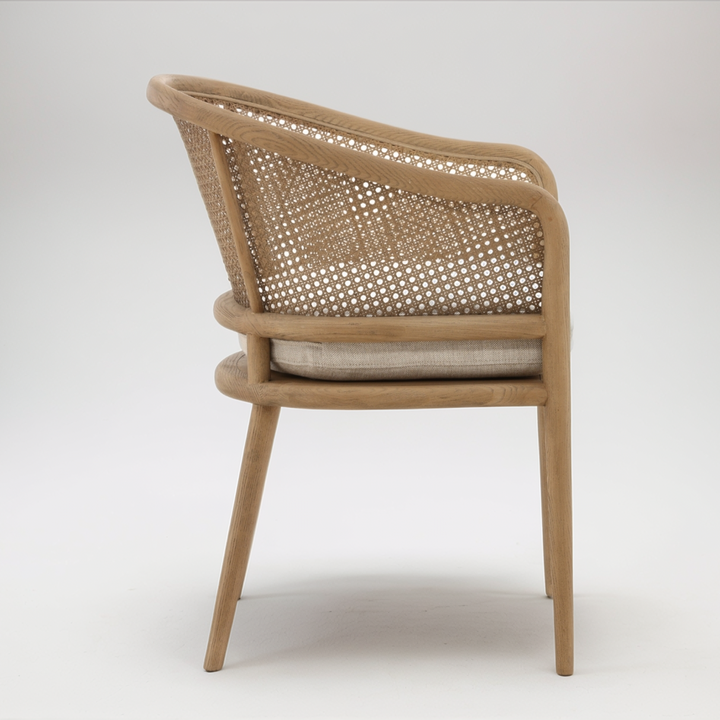 Wicker chair with a cushion on a white background