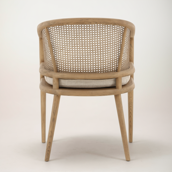 Wooden chair with woven backrest and cushion on a white background