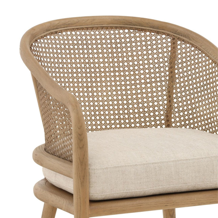 Wicker chair with a cushion on a white background