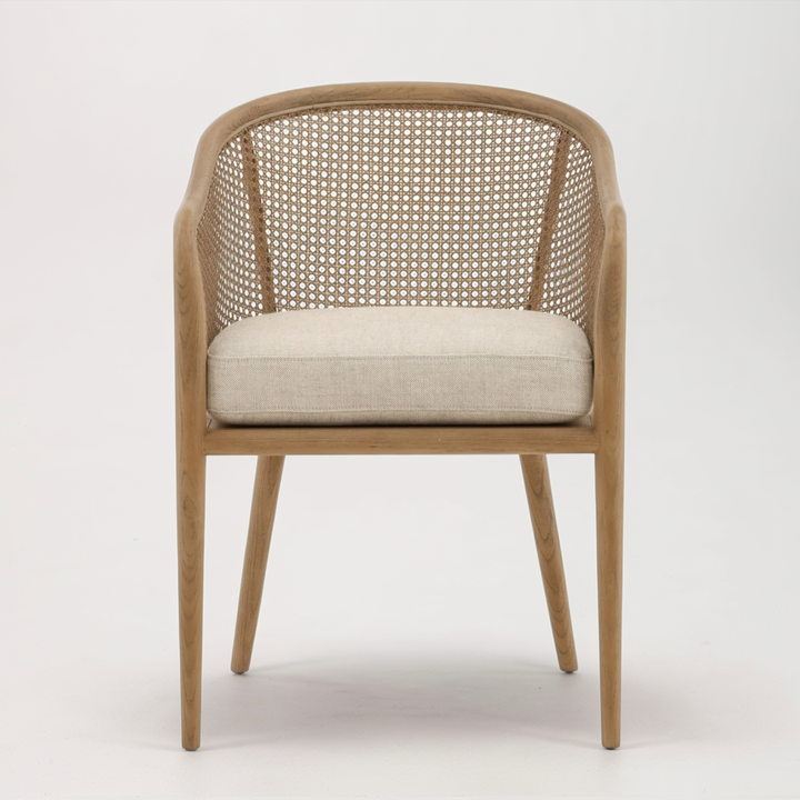 Wooden chair with woven backrest and beige cushion on a white background