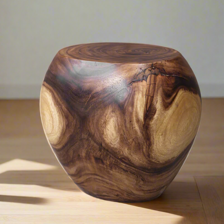 Wooden stool with a natural grain pattern on a wooden floor.
