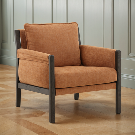 Brown armchair with wooden frame on a wooden floor