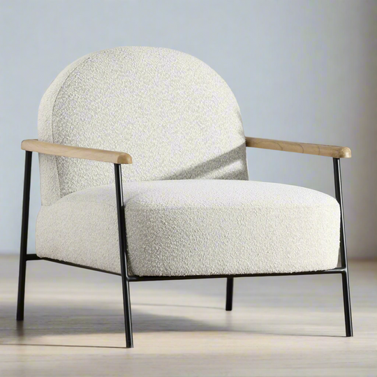 Modern armchair with white textured upholstery and wooden arms on a neutral background