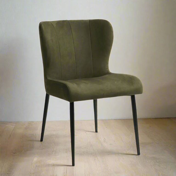 Green upholstered chair with black legs on a white background