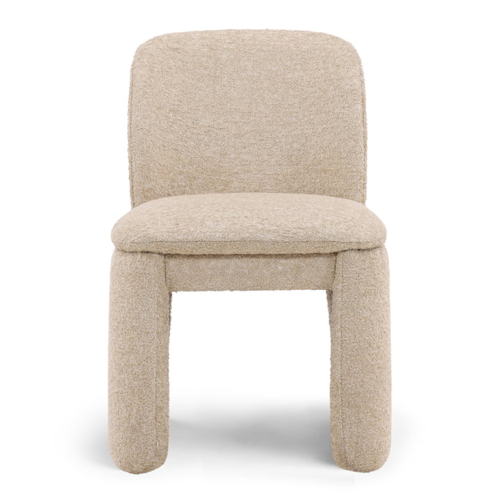 Beige textured chair in a neutral room with wooden floor