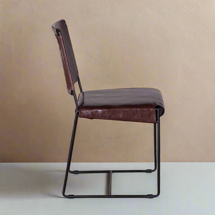 Brown leather chair with black metal frame on a white background