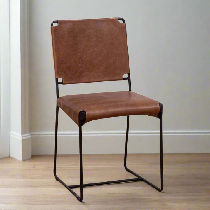 Brown leather chair with black metal frame on a white background