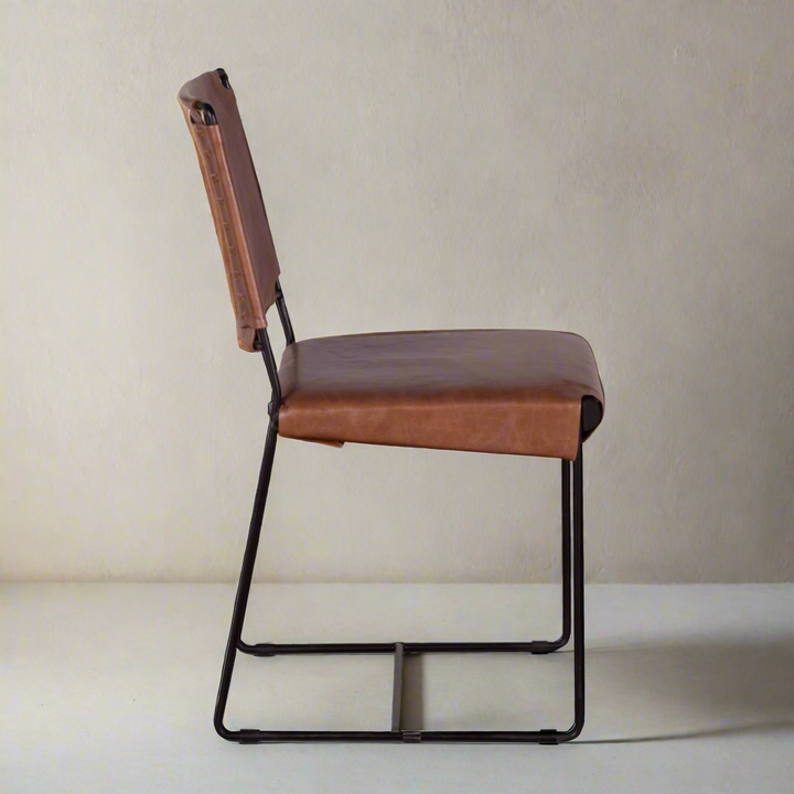 Brown leather chair with black metal frame on a white background