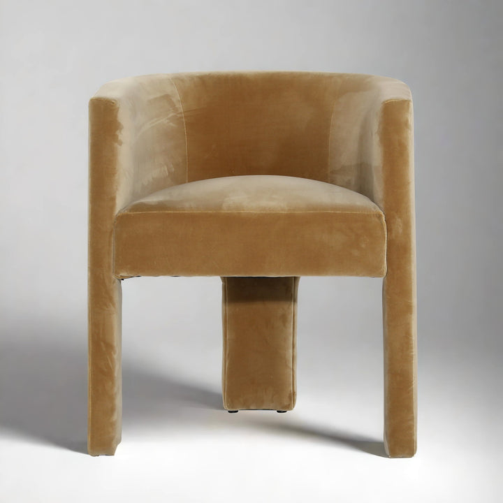 Beige velvet chair on a wooden floor with a neutral background