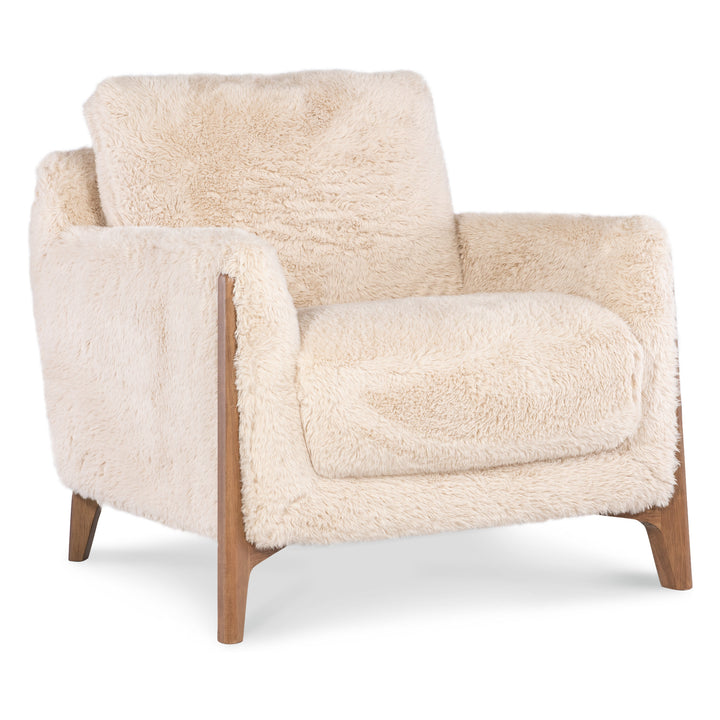 Angled view of a cream-colored faux-shearling accent chair with mid-century modern wooden legs.