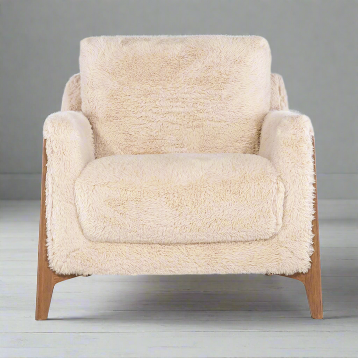 Cream-colored faux-shearling accent chair with mid-century modern wooden legs