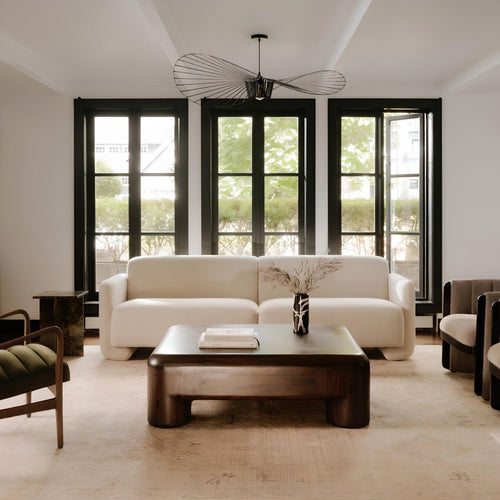  Modern coffee table with stylish chair and elegant lighting.