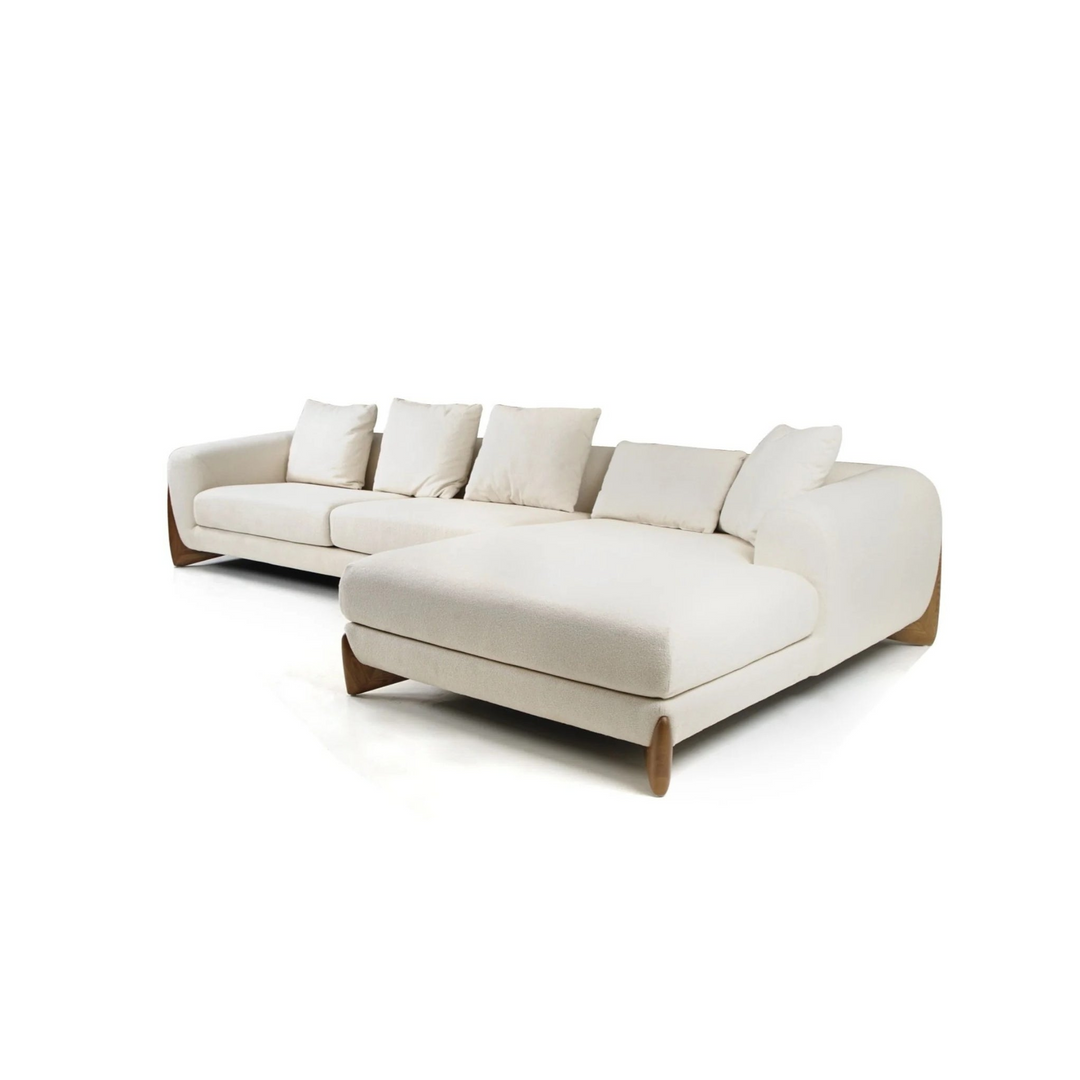 A modern, plush beige sectional sofa with five back cushions and stylish wooden legs, ideal for contemporary living spaces.