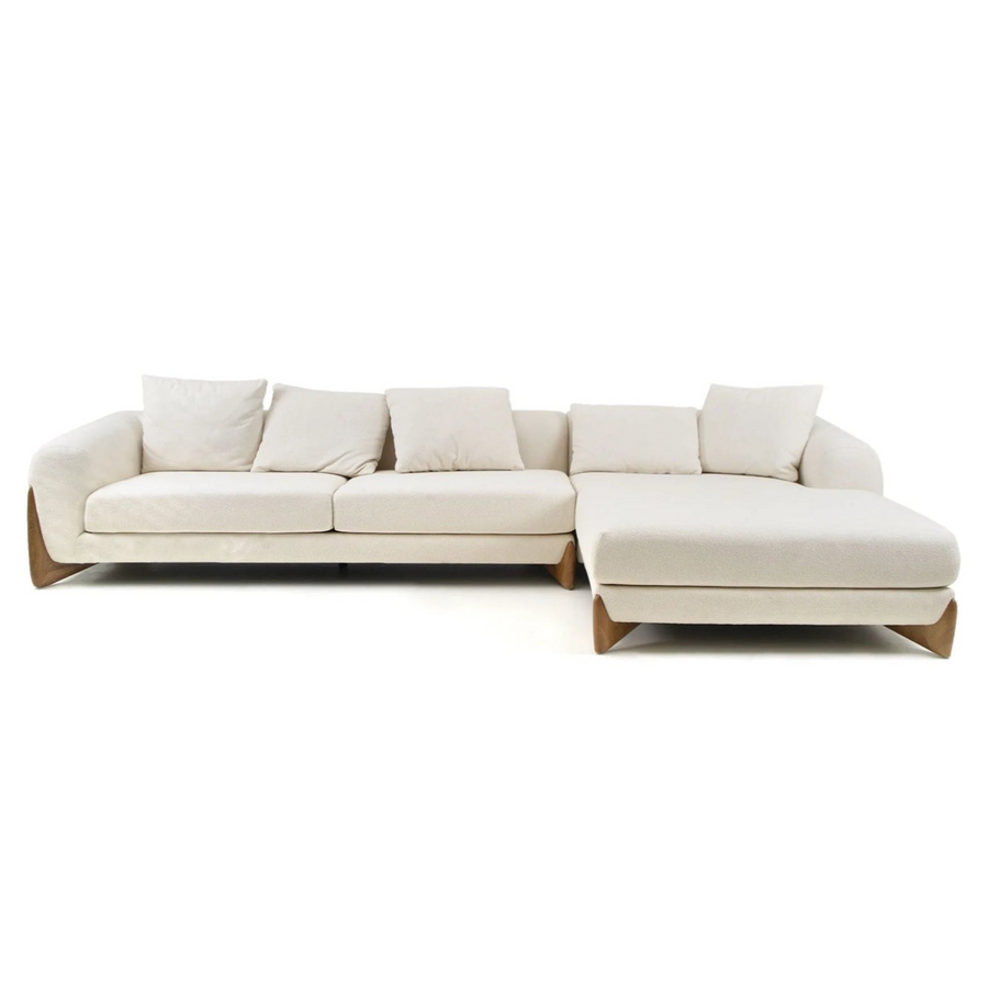 A modern, plush beige sectional sofa with five back cushions and stylish wooden legs, ideal for contemporary living spaces.