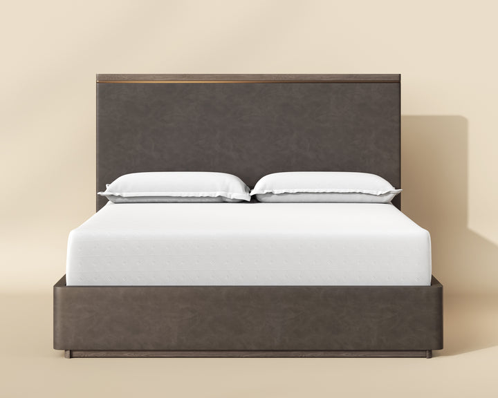 Modern altman double bed with a dark gray upholstered headboard, white mattress, and decorative pillows, set against a warm beige background.