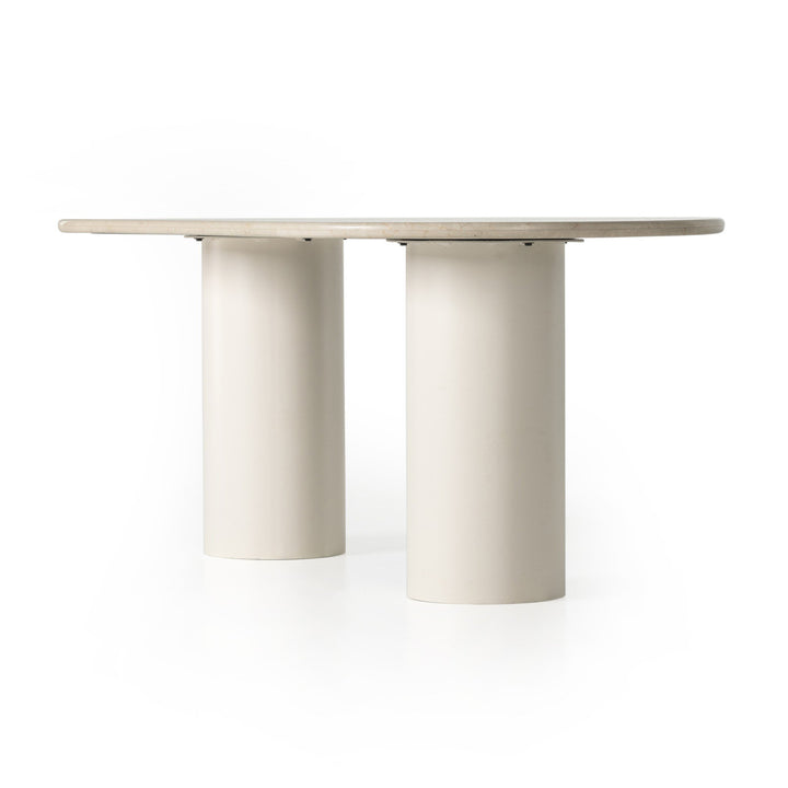 A minimalist round table with a smooth marble top supported by two plain cylindrical cream-colored bases.