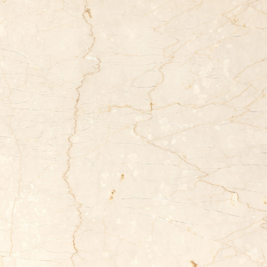 Top view of a smooth, light-colored marble table surface, showcasing delicate veins and subtle texture.