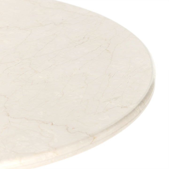 Close-up of a smooth, light-colored marble table surface, showcasing delicate veins and subtle texture.