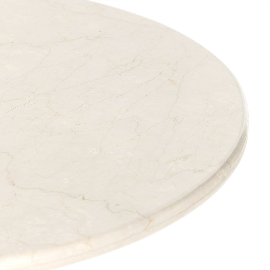 Close-up of a smooth, light-colored marble table surface, showcasing delicate veins and subtle texture.