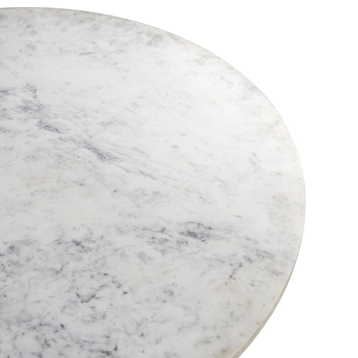 Close-up of a round white marble tabletop with subtle gray veining, showcasing its smooth, polished surface and elegant design.