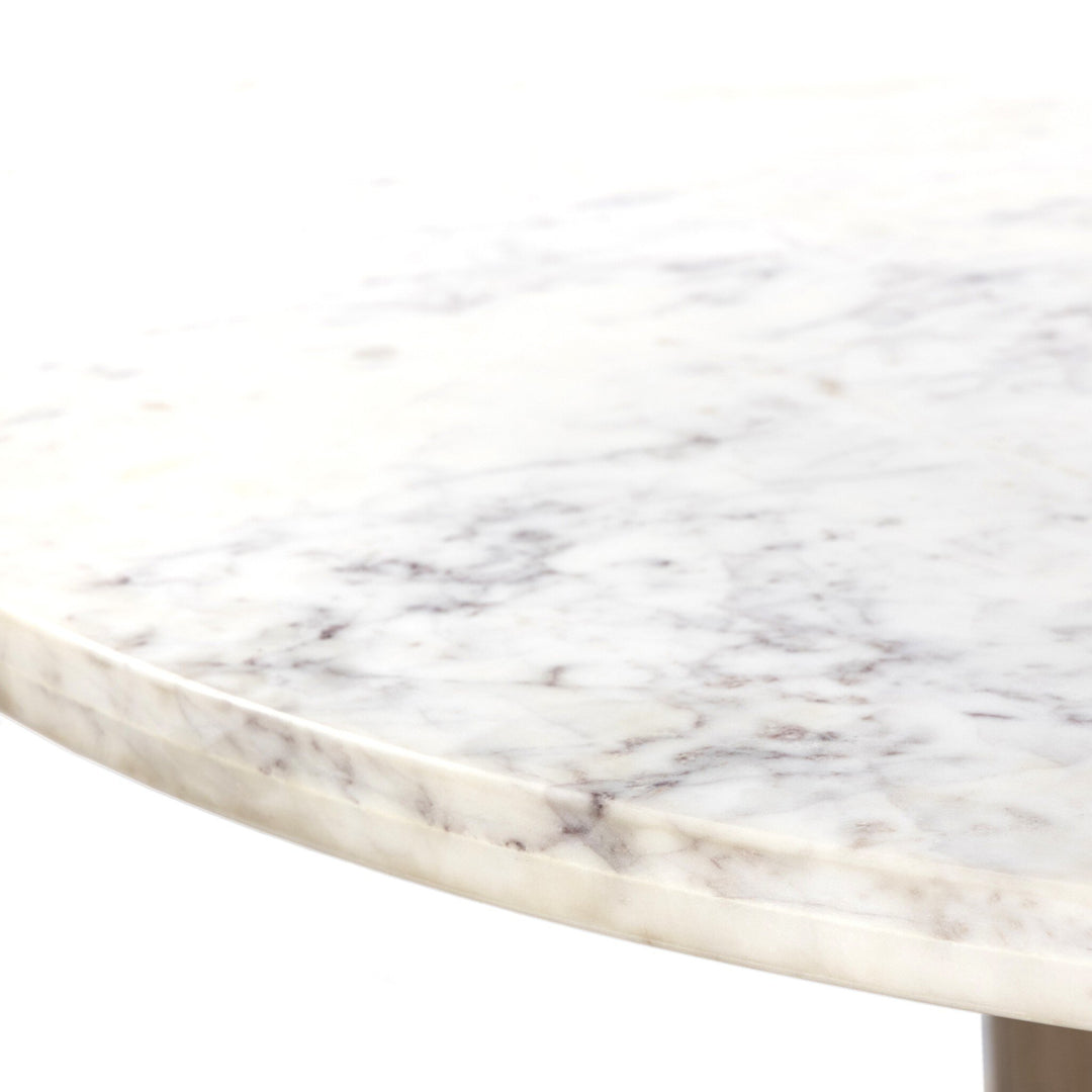 Close-up of a polished white marble surface with subtle gray veining and a smooth, rounded edge. Ideal for modern decor.