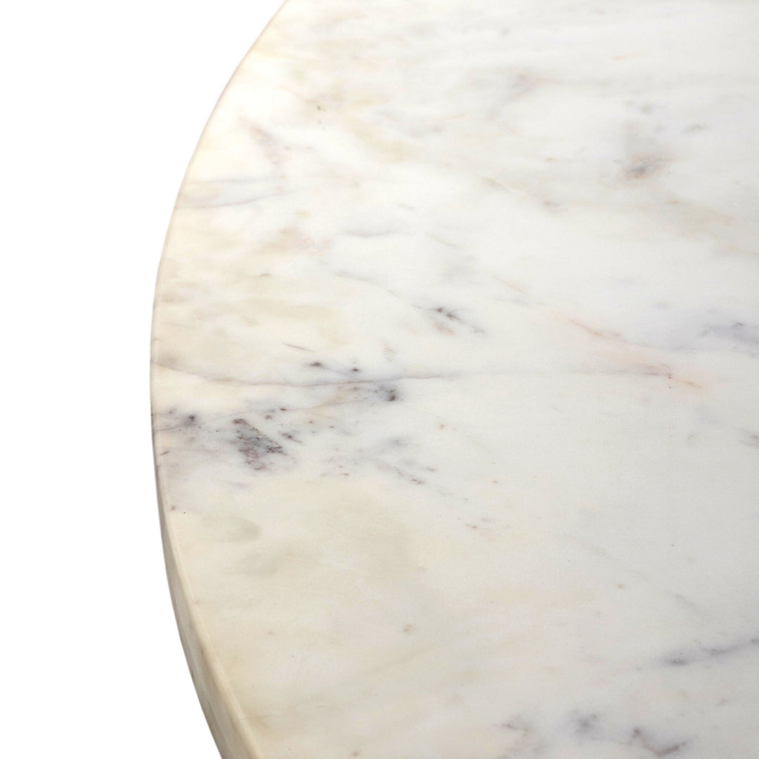 Close-up of a polished white marble surface, showcasing subtle gray veins and a smooth, glossy finish.