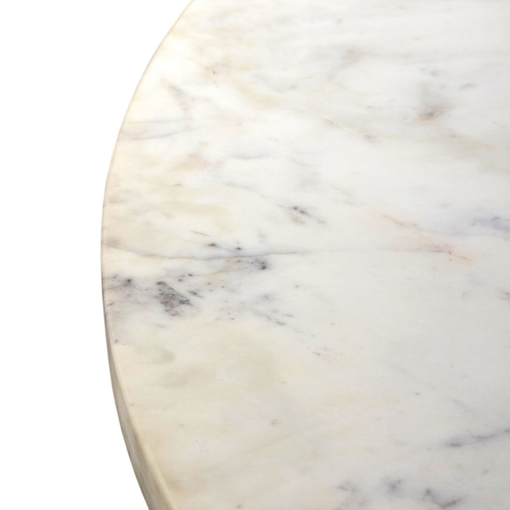 Close-up of a polished white marble surface, showcasing subtle gray veins and a smooth, glossy finish.