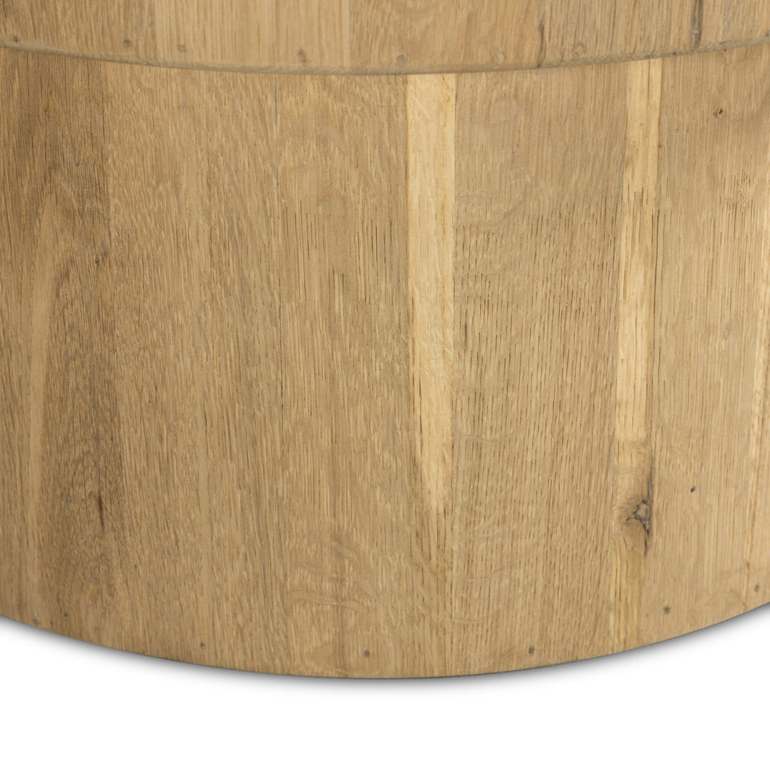 Close-up of a cylindrical wooden surface, showcasing a natural, light-colored wood grain with subtle textures and seams.