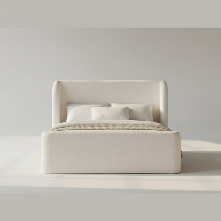 white upholstered bed with curved headboard and footboard, white bedding, knit throw