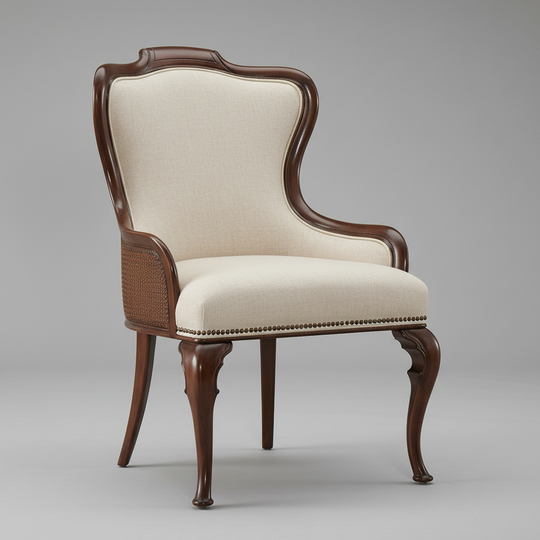 A classic high-back accent chair with a dark brown carved wood frame, cream-colored fabric upholstery, and a woven cane back panel, shown on a neutral gray background.