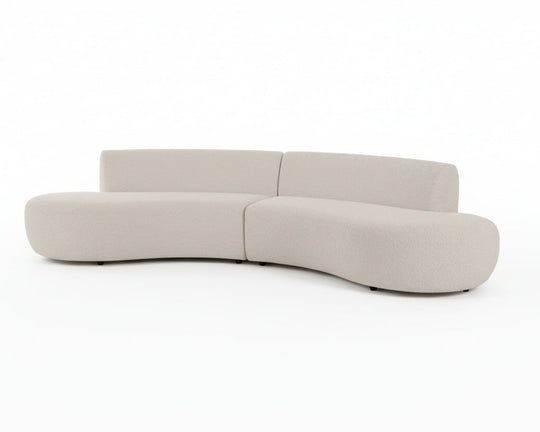 Curved, contemporary beige sofa with plush textures and rounded edges.