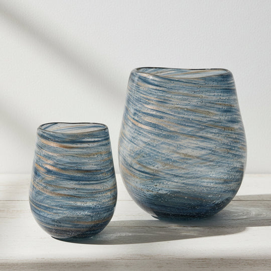 Two glass vases with a swirled blue and gold geometric pattern, one larger than the other.