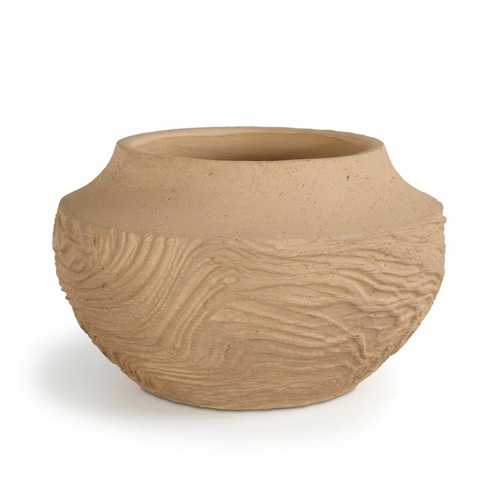 Terracotta pot with textured surface on a white background