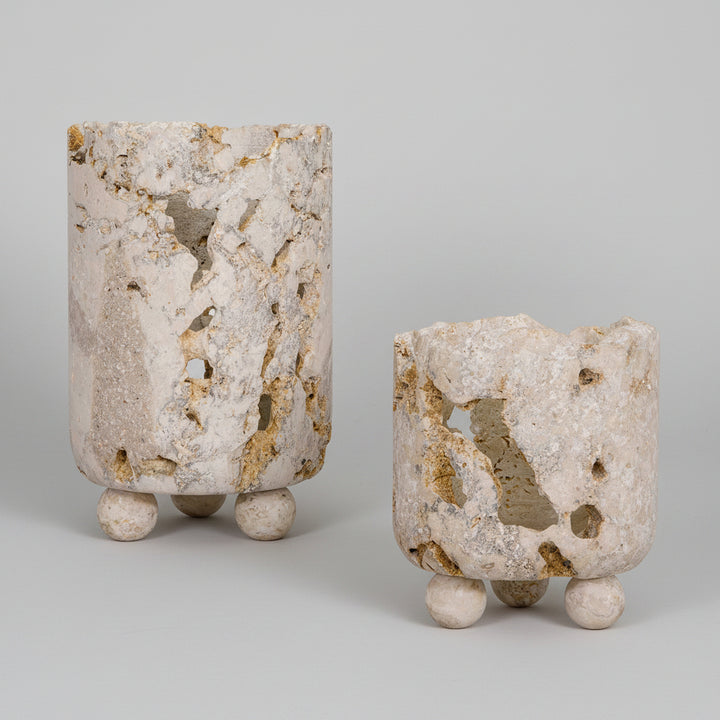 Two stone-like vases with natural patterns on a white background
