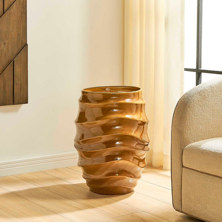 A glossy, ribbed ceramic vase in a warm brown glaze