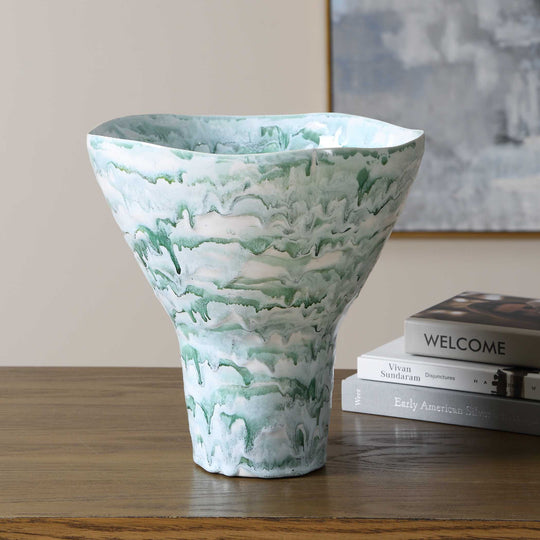 A tall, flared ceramic vase with a white and mint green marbled pattern