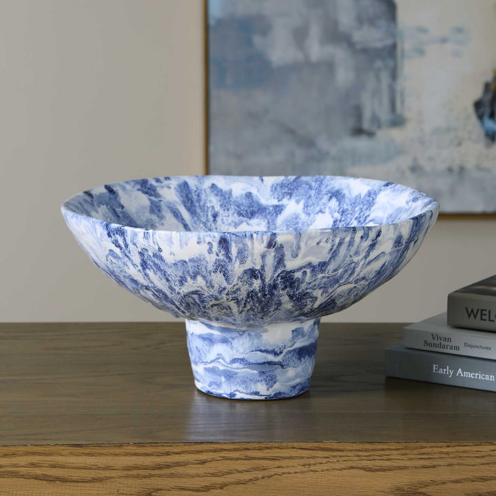 A blue and white marbled ceramic bowl with a pedestal base