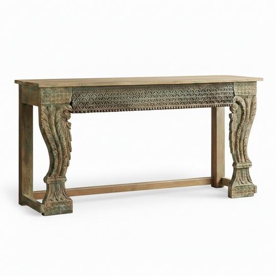 Decorative wooden console table with intricate carvings on a white background