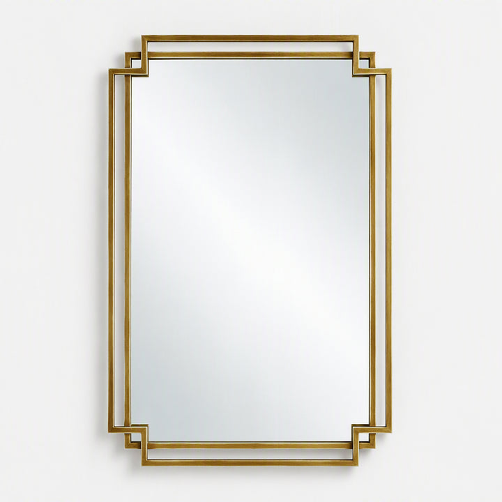 A rectangular wall mirror with a decorative gold geometric frame, shown against a plain light gray background.