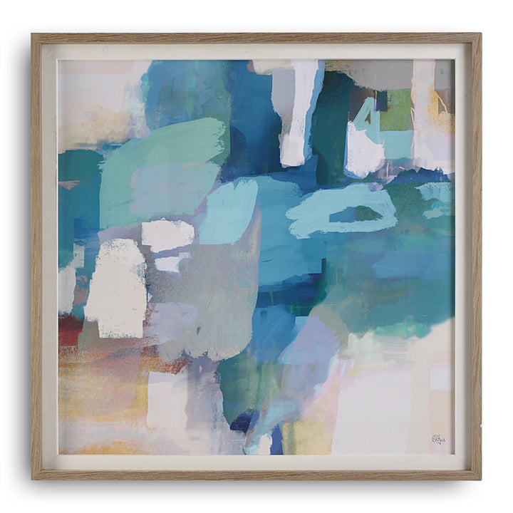 A framed abstract print featuring shades of azure and cyan with pops of white and yellow, bordered by a white linen liner and a pine wood frame in light gray stain with white wash accents.