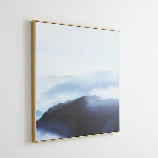 Framed artwork of a mountain landscape with a gold frame