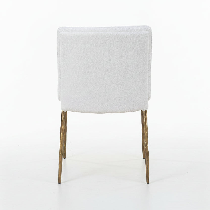 off-white upholstered chair with gold legs