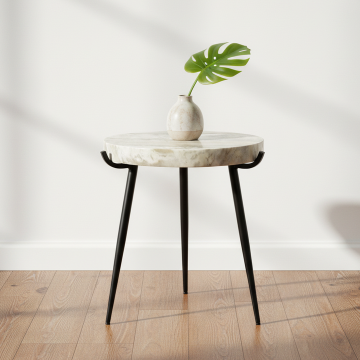 round side table with a natural stone top featuring beige and gray marbling, supported by three slim black metal legs