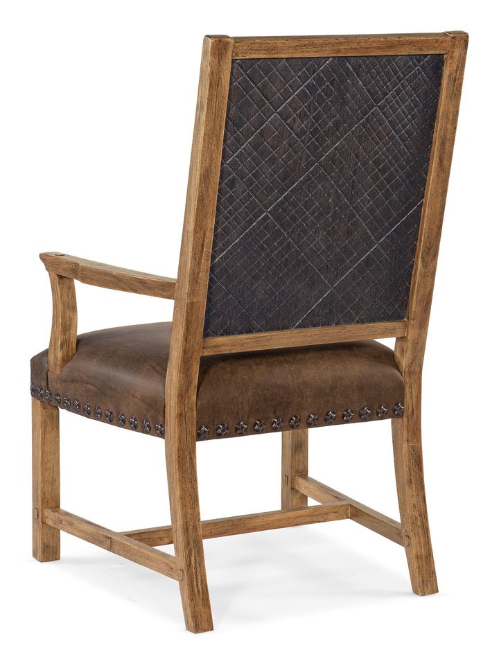 Wooden armchair with brown leather seat and quilted backrest on a white background