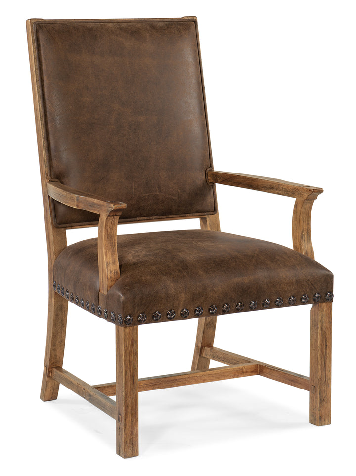 A rustic brown leather armchair with a high back, wooden frame, and nailhead trim on the seat, shown against a plain white background.