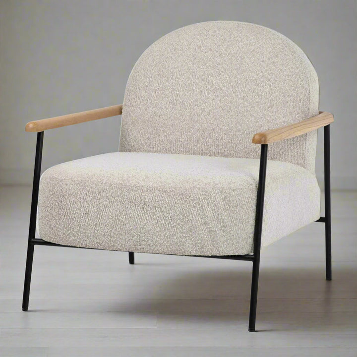 Beige armchair with wooden arms and black metal legs on a white background