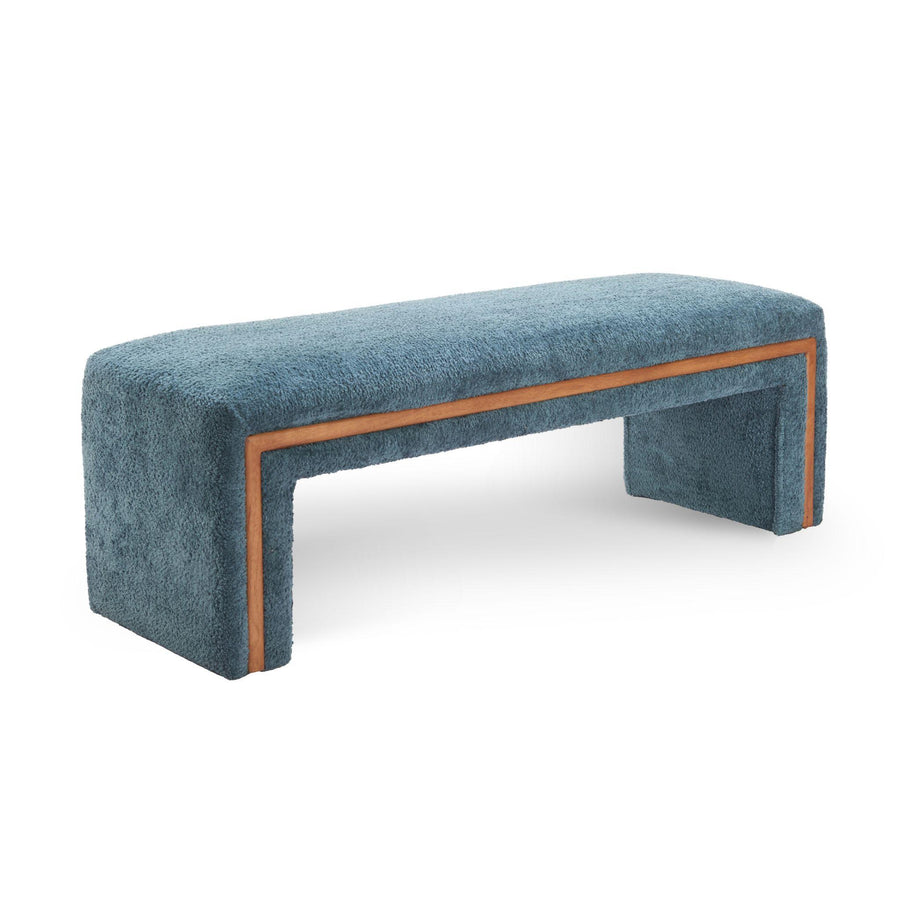 Blue upholstered bench with brown trim in a bedroom setting